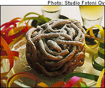 A funnel cake on a glass plate surrounded with paper streamer.