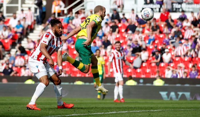 Footballer Teemu Pukki jumping to head the ball.