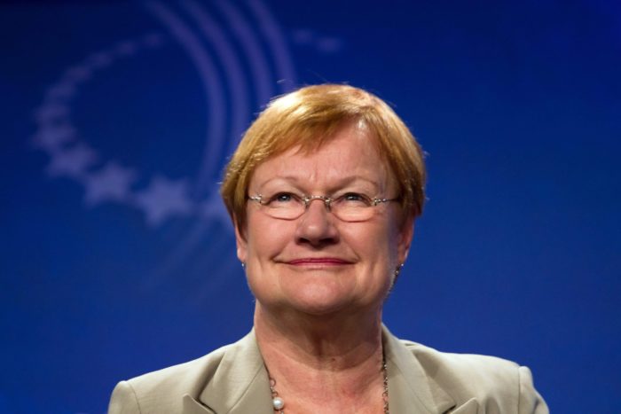 A woman smiles at the camera.